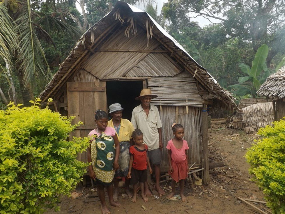 Three generations in a damaged house. Antalaha, Madagascar