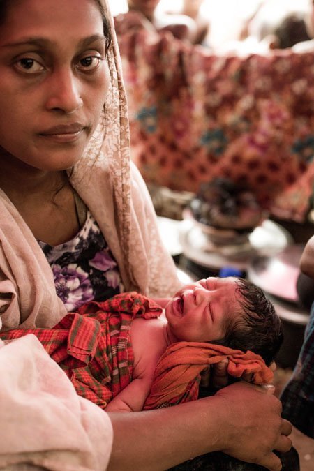 Maimuna and her infant daughter are refugees from Myanmar living in a makeshift shelter in a settlement in Bangladesh.
