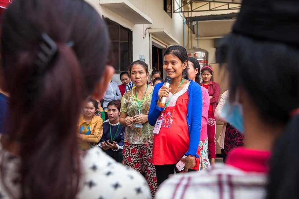 Maly participates during an outdoor contraception activity at a garment factory. 