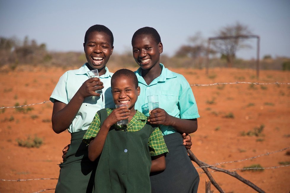 Girls enjoy clean water from a newly drilled borehole in Chivi District, Zimbabwe.
