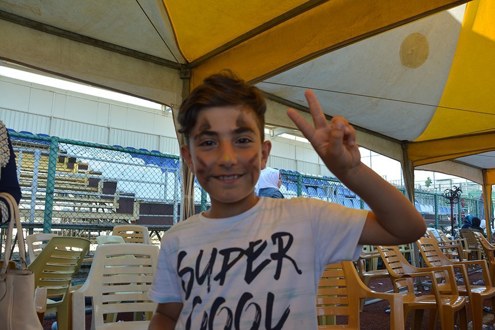 Hassan shows off his painted face during the children's festival in Kilis, Turkey.