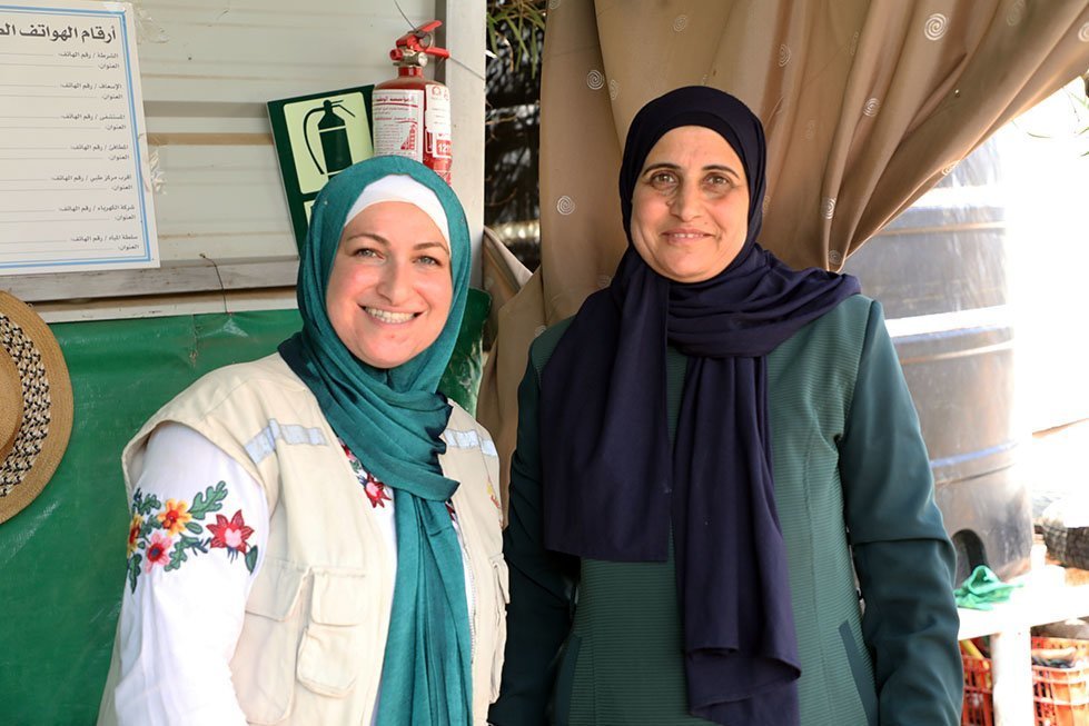 May (left) with Iman (right), one of the founding members of a cooperative of female organic farmers in a remote community in Nassareyeh in the Jordan Valley in the West Bank. Laura Banks/CARE