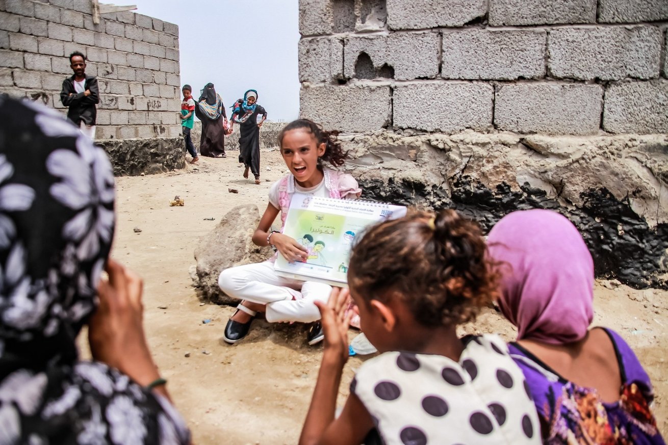 Amaal demonstrates good hygiene practices to other children in her community in the Al Buraiqah district of Aden, Yemen