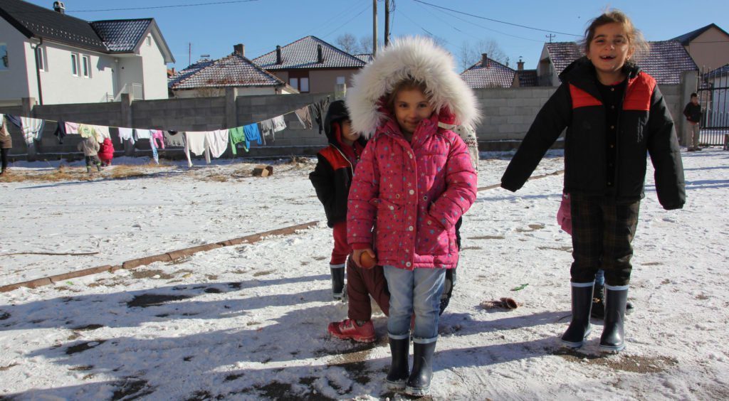 Syrian children play in the snow in a temporary shelter for refugees in Sjenica, Serbia