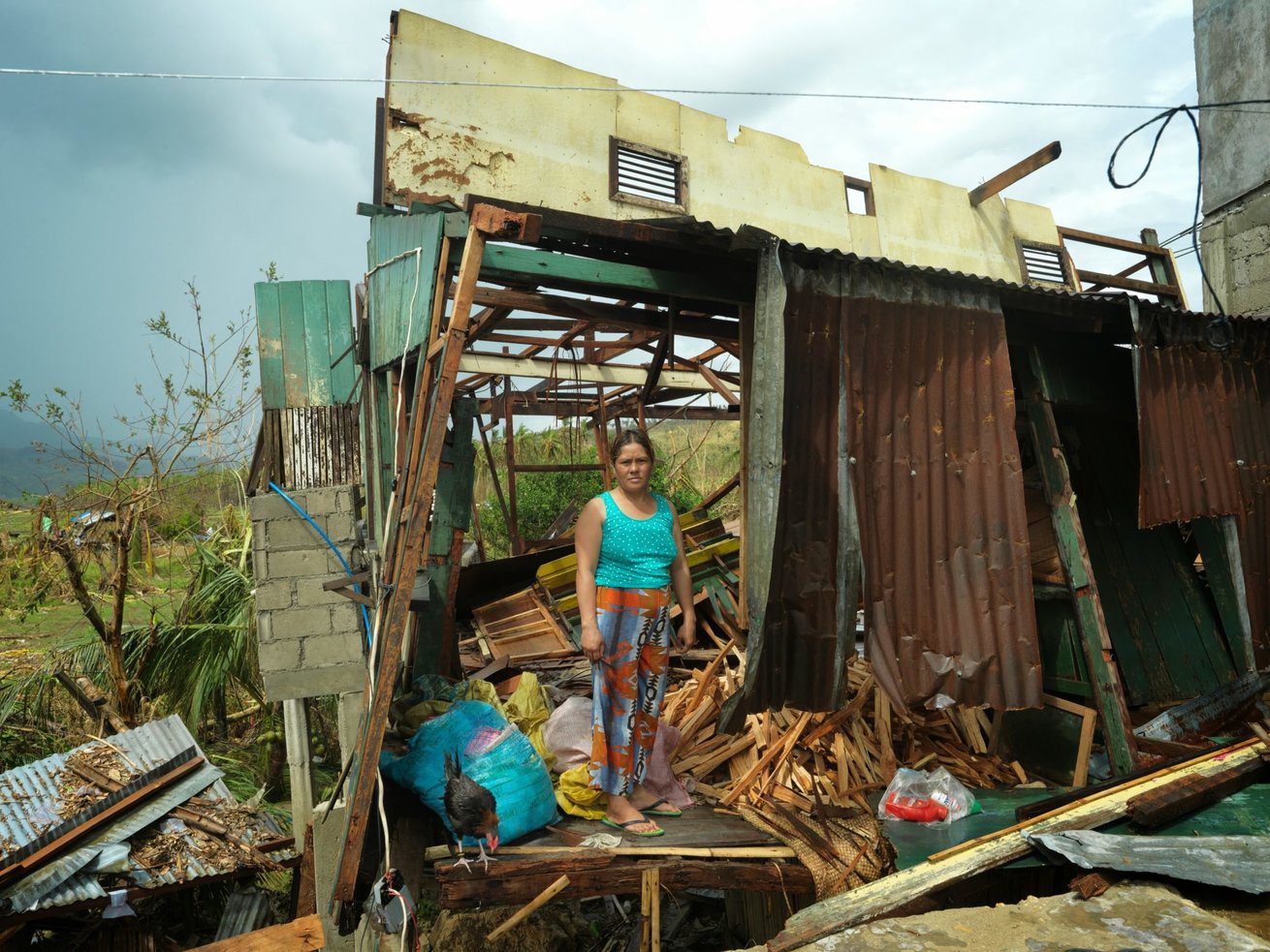 A women in her devastated home after typhoon Haiyan hit Merida village in the Philippines. 