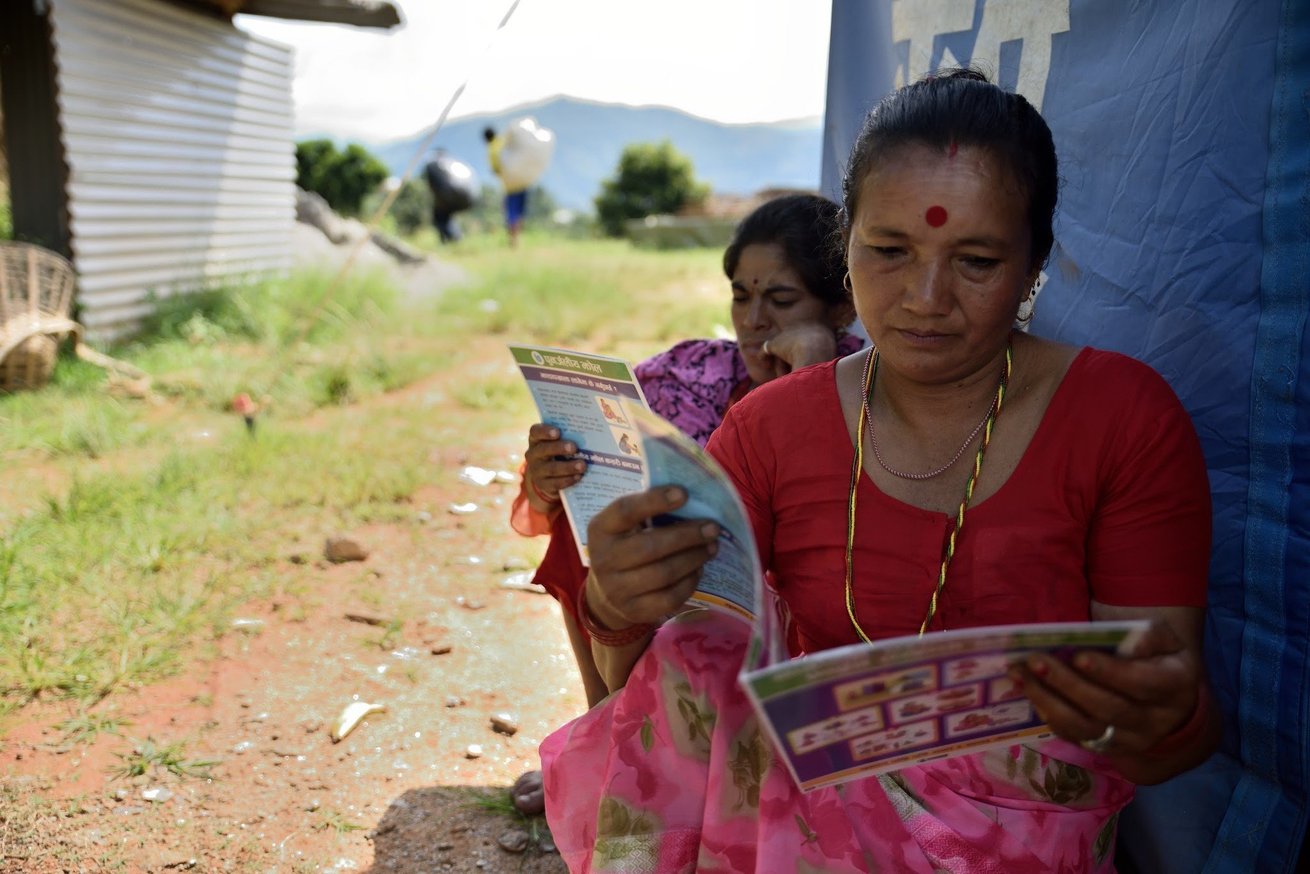 Women read brochures on water, sanitation and hygiene in Nepal