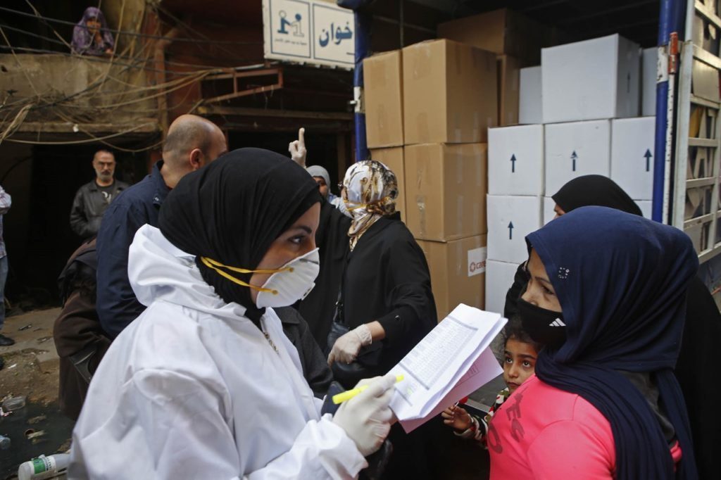 CARE staff fill vans with food parcels and hygiene items, in partnership with Lebanese NGO Sanabel al-Nour. CARE distributed food and hygiene packages to 300 vulnerable families in Tripoli, Northern Lebanon.