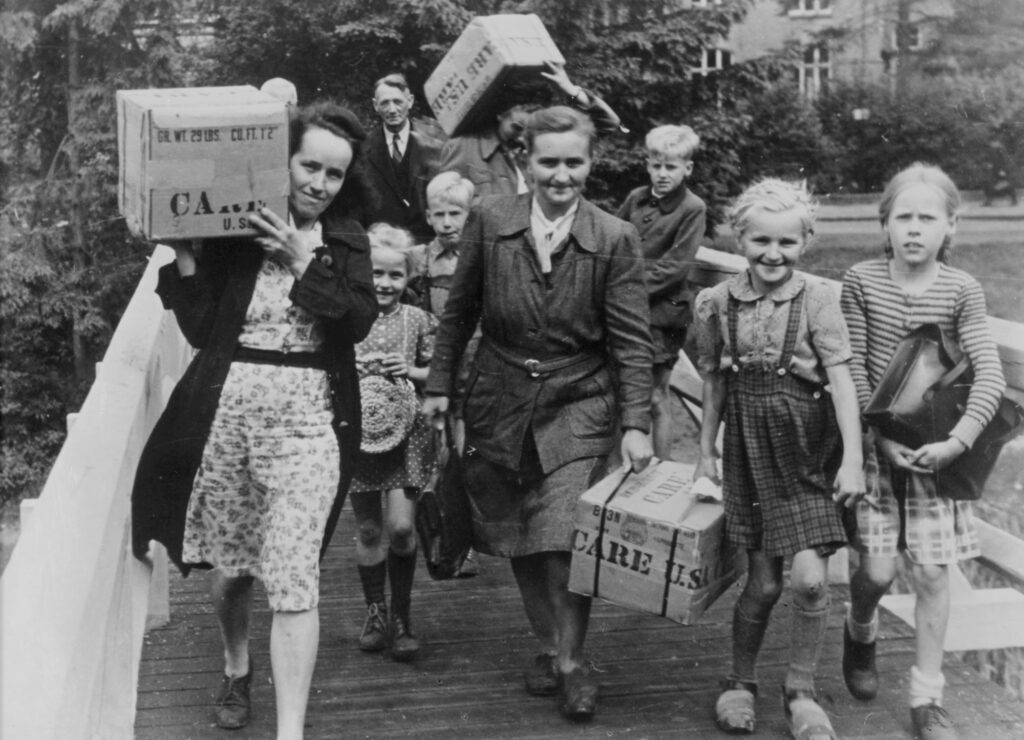People carrying CARE packages