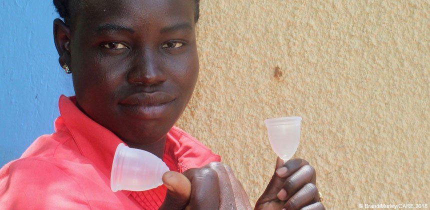 A woman holds Ruby cups in Uganda.