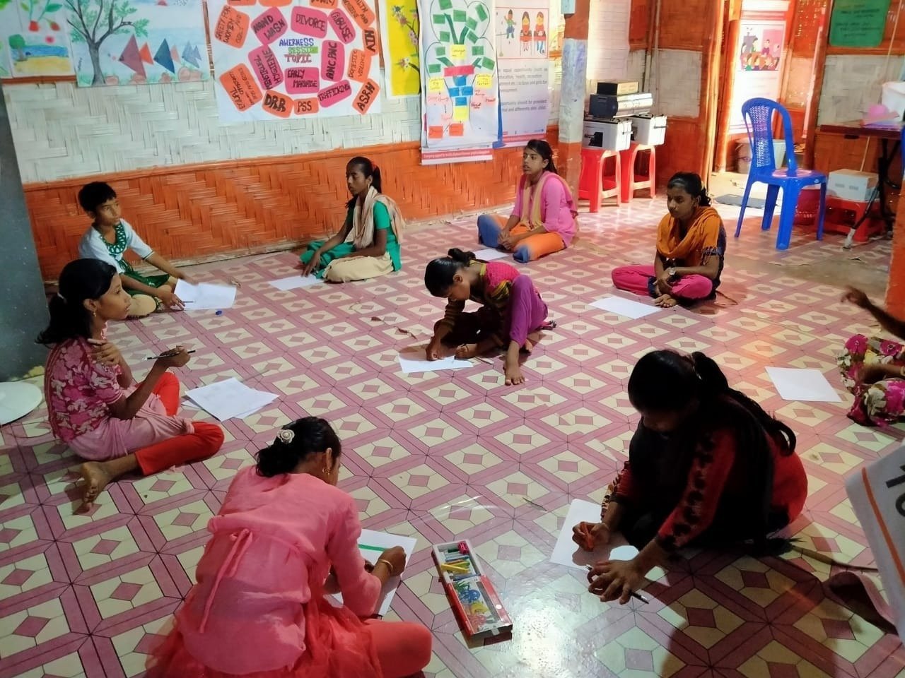 Girls participate in a drawing session at the Women and Girls' safe space in Cox's Bazar refugee camp, Bangladesh