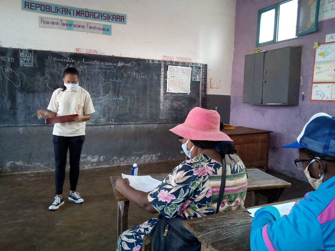 CARE Madagascar staff conducting a local disaster risk reduction committee involved in conducting Covid-19 response activities.