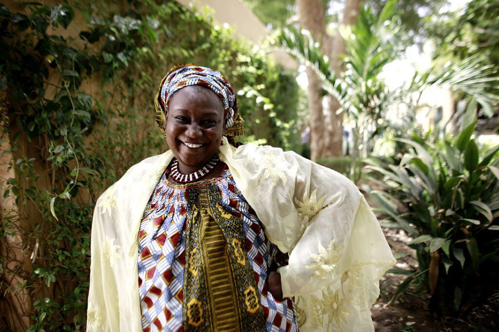 Salamatou Dagnogo was stranded in Niger after her abusive husband put her on a bus, knowing she would not have enough money to return to Côte d’Ivoire. In Niger, she joined a Village Savings and Loan Association (VSLA), a co-op that allows women to be their own bankers. After 18 months, Salamatou used her earnings to purchase a bus ticket back to Côte d’Ivoire where she was reunited with her children. Photo by Josh Estey/CARE