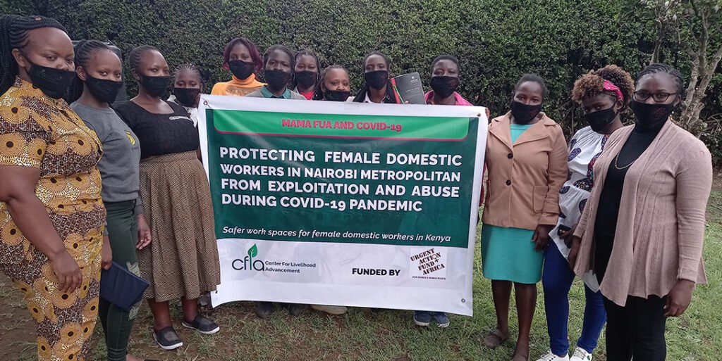 Mama Fuas group leaders gathered holding up a banner that reads "Protecting female domestic workers in Nairobi metropolitan from exploitation and abuse during COVID-19 pandemic. Safer spaces for female domestic workers in Kenya." Photo: Center For Livelihood Advancement (CFLA)