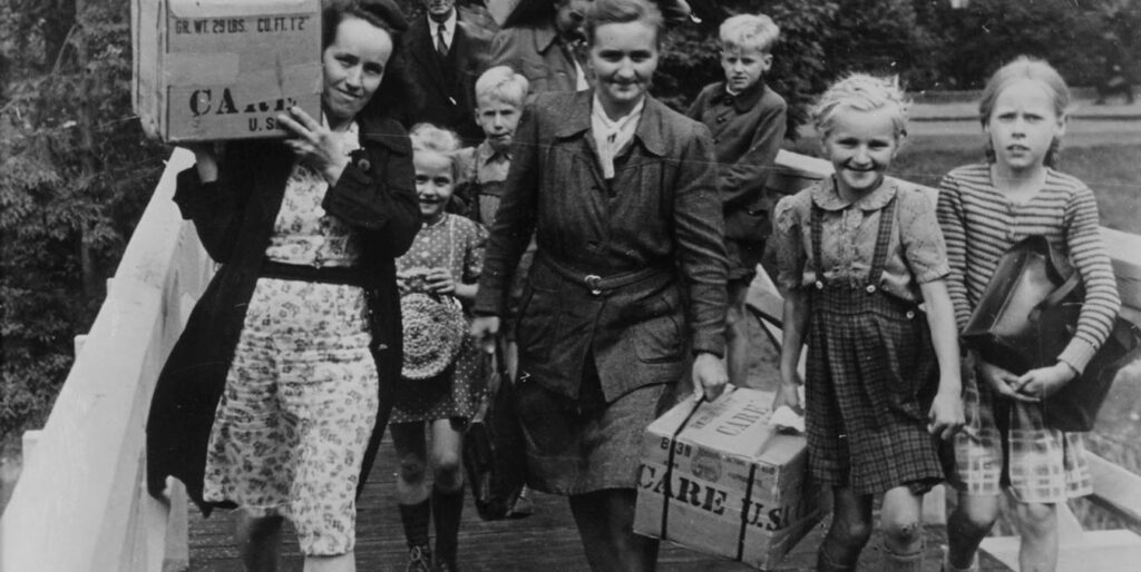 People with CARE Packages® in Germany after the Second World War. ©CARE