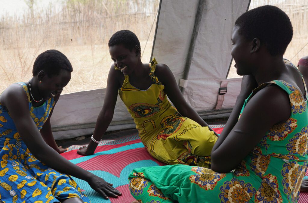 Adolescent girls chatting at their weekly meeting at the Women and Girls friendly space Center in Borin Bor, South Sudan. Credit: Campeanu 2021