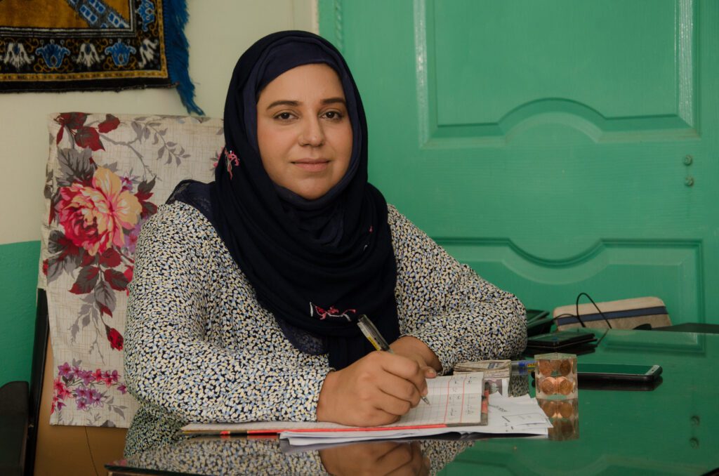 Hina runs the ‘Anabia’ girls’ hostel in Islamabad, Pakistan. She sits proudly at her desk. CARE Pakistan
