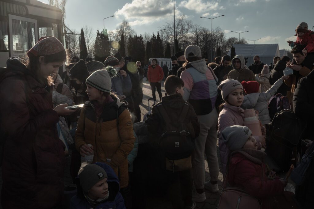 Polish volunteers and authorities provide help for Ukrainian refugees as they arrive in Mlyny reception point with buses from the border crossing, in Przemsyl, eastern Poland. Francesco Pistilli