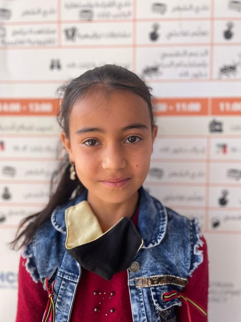 A young girl, Habiba, who lives in Azraq camp in Jordan, is pictured looking at the camera. Photo: Suhaib Al Jizawi/CARE