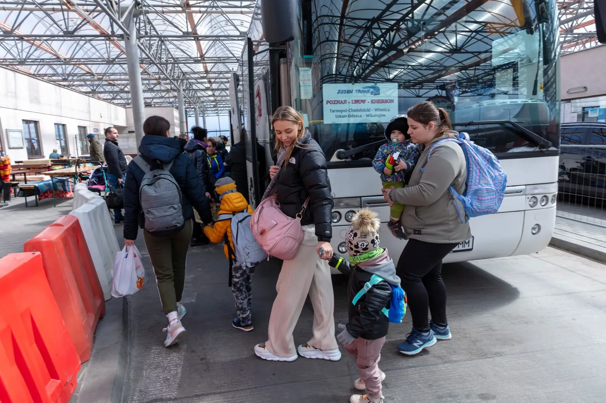 Ukrainian refugees, including Valeria and her son Misha, cross the border into Poland near the town of Hrebenne. In the border zone between Ukraine and Poland, refugees that cross on buses must pass through a checkpoint with their luggage.