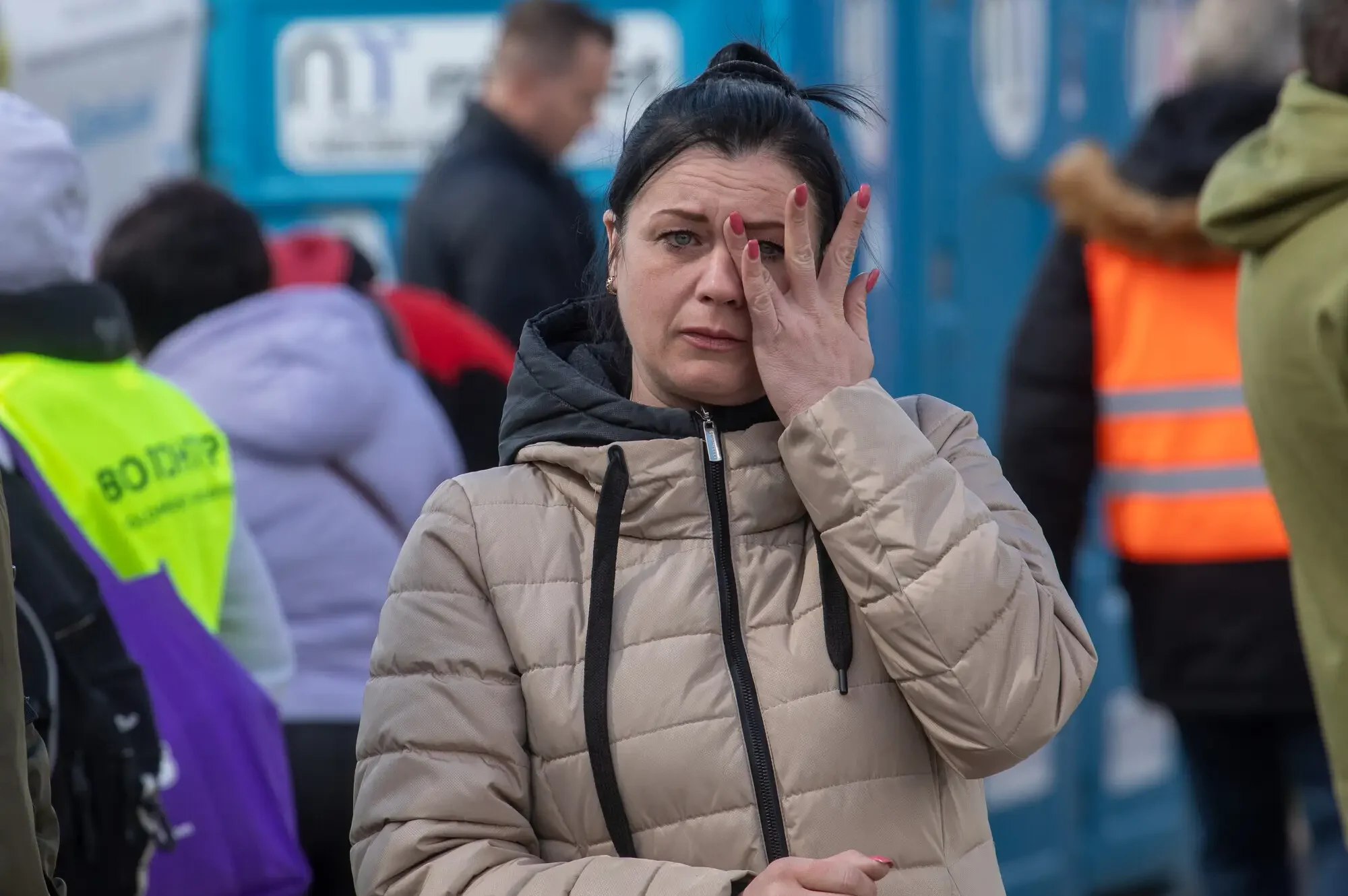 Ukrainian Tatiana Medzatova waits at the Medyka, Poland border crossing point, for her two children, one adult and one teenager, to arrive from Ukraine. Przemysl is a crossing point set up for refugees crossing on foot. Tatiana had just received a call that her family was only an hour away.