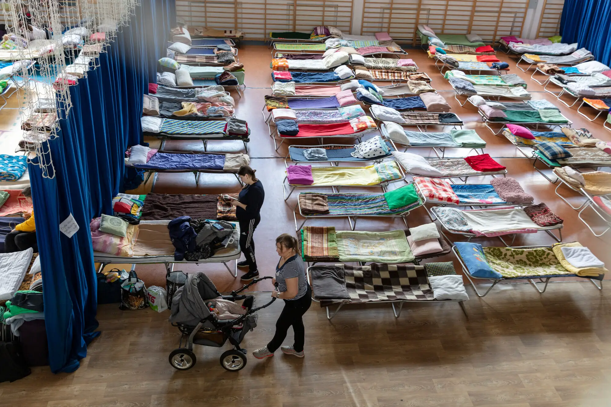 A school gym, Hala Sportowa, Lubycza Królewska, serves as temporary housing for refugees in the Polish border town, Hrebenne.
