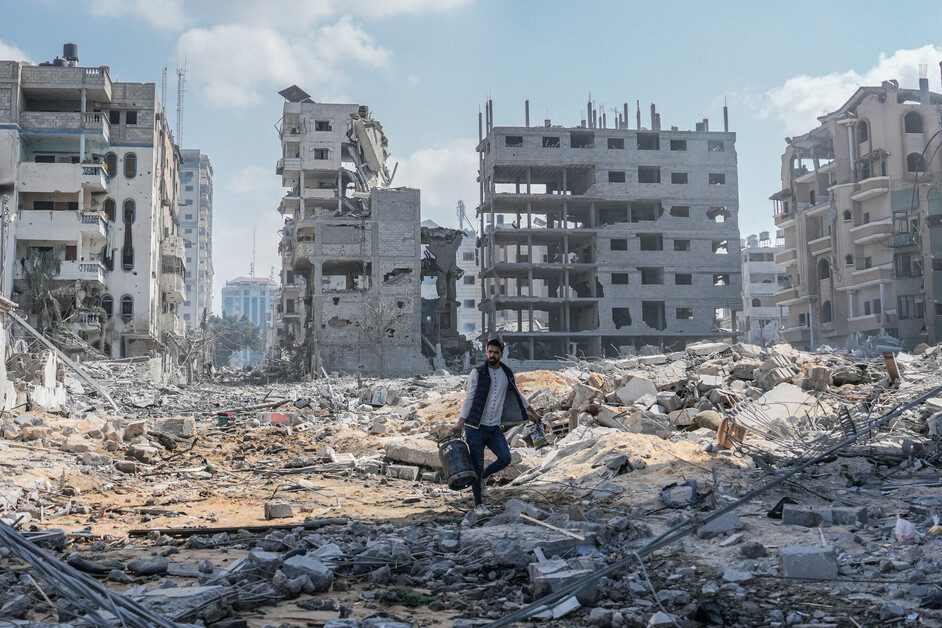 A Palestinian man walks among the debris of his house after it was destroyed by an Israeli airstrike in the al-Rimal neighborhood of Gaza City.