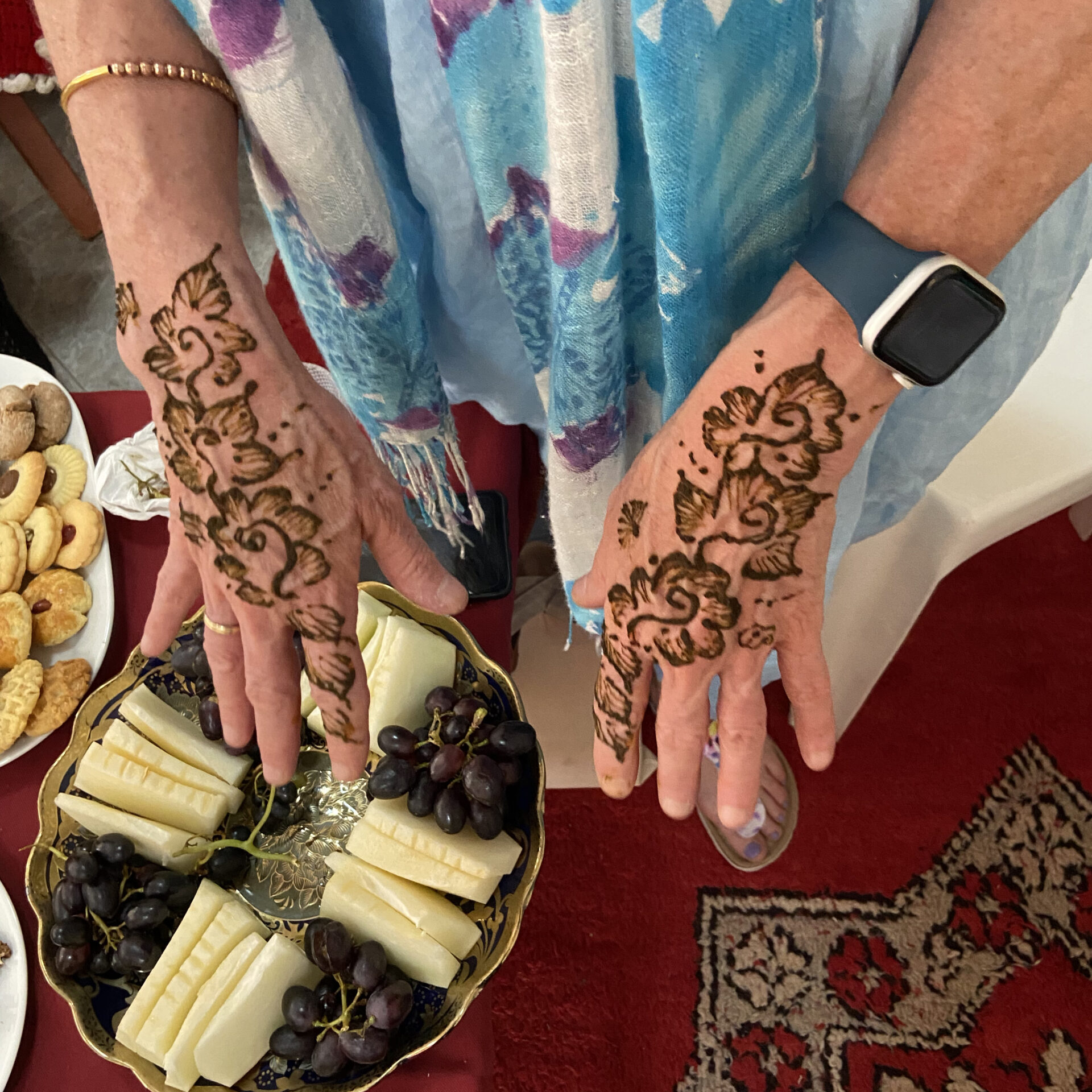 Close up of hands with recently applied henna on them.