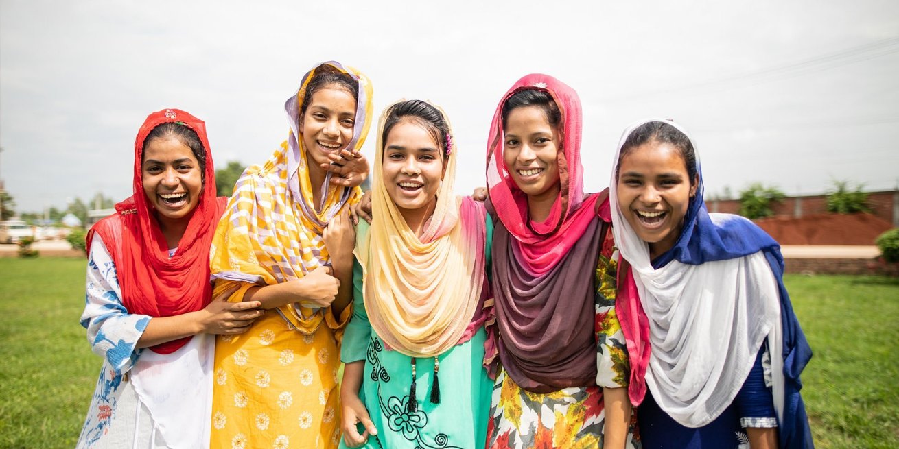 Participants, from left to right; Mst. Samsuara (red headscarf), Mohona Akter (yellow dress), Surma (green dress), Mim Ara (pink headscarf) and China Akter (dark blue dress), from The Empowering Women Workers in Bangladesh training.